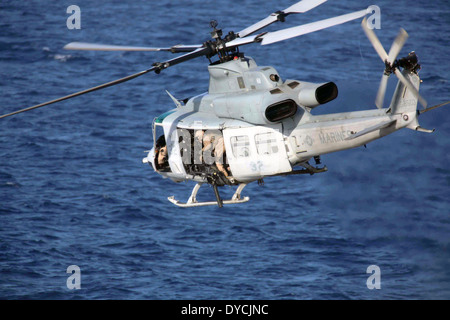 A US Marine Corps UH-1Y Huey helicopter transport a visit, board, search and seizure training mission April 11, 2014 off the coast of San Diego, California. Stock Photo