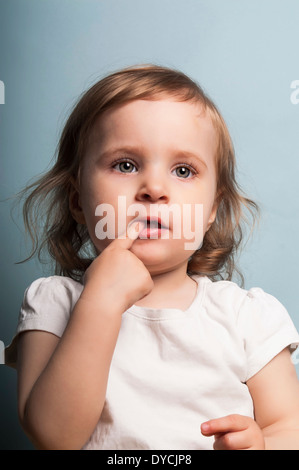 portrait of a baby girl with a distant gaze Stock Photo