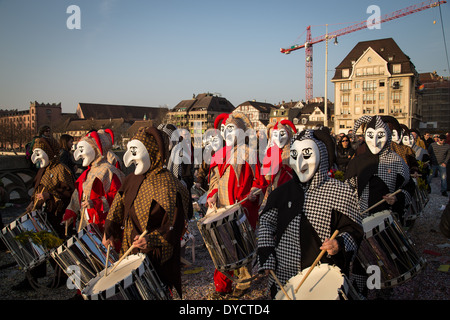Group of so called Waggis with drums walking through the streets at the Basel carnival in Switzerland. Stock Photo