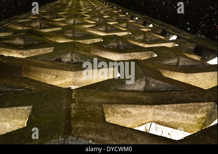 Diamond shaped cast concrete wall stones a  strong barrier that still allows light through screencast Stock Photo