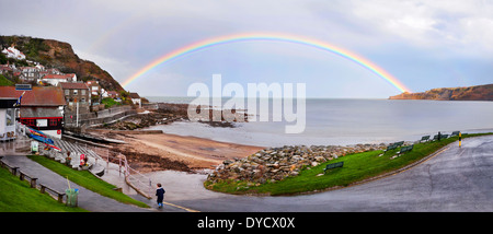 Rainbow over Runswick Bay, North Yorkshire, UK, after heavy rainstorm. Stock Photo