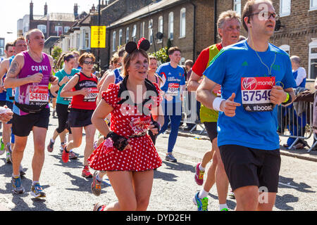 London UK. 13 April 2014 London Virgin Money Marathon runner 54745 Jackie Scarfe of Great Britain running as Minnie Mouse in a red polka dot outfit Credit:  John Henshall/Alamy Live News JMH6154 Stock Photo