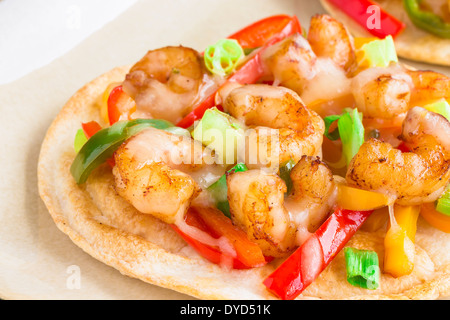 Spicy shrimp pizza made of cumin shrimp, red, yellow and orange bell peppers, jalapenos, green onions and pepper jack cheese Stock Photo