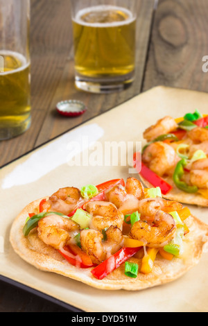 Spicy shrimp pizza made of cumin shrimp, red, yellow and orange bell peppers, jalapenos, green onions and pepper jack cheese Stock Photo