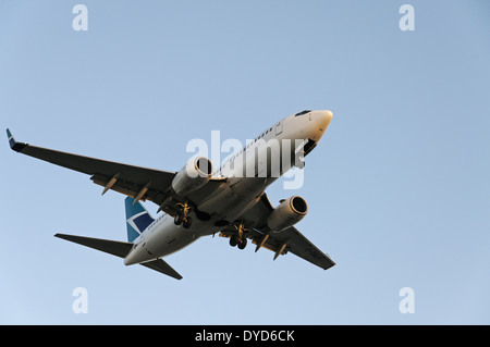A Westjet Airlines Boeing 737 (737-700) narrow-body jetliner on final approach for landing at Vancouver International Airport Stock Photo