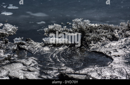 Close-up of melting ice on the beach of an Alaskan river near break up. Stock Photo