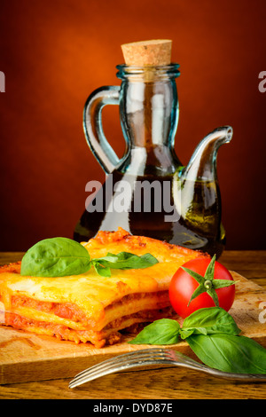 traditional lasagna bolognese and bottle of olive oil Stock Photo