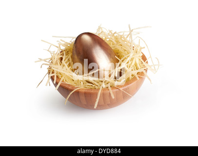 A wooden bowl of chocolate Easter Eggs on a white background. Stock Photo