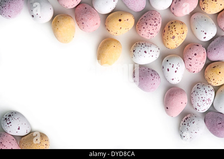A selection of chocolate Easter Eggs with a candy crunchy shell on a white background. Stock Photo