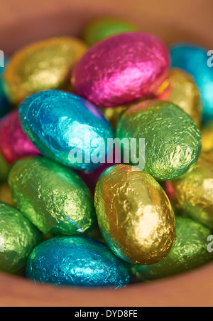 Colouful foil wrapped easter eggs in a bowl. Stock Photo