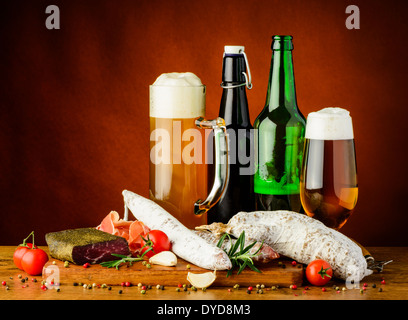 still life with traditional sausages and glass and bottle of beer Stock Photo