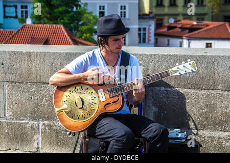 A street musician plays an Amistar Resophonic guitar on Charles Bridge in Prague. Stock Photo