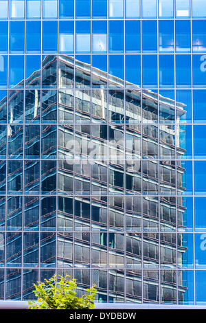 One modern glass highrise office building reflected in another on the Kirchberg Plateau in Luxembourg city. Stock Photo