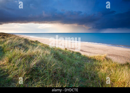 Sand dunes at Horsey and a dramatic summer storm out at sea. Stock Photo