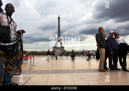 A souvenir seller and tourists on the Trocadero. Stock Photo