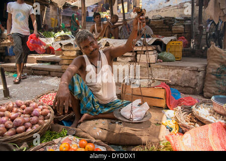 Enviromental shot of market trader in old Varanasi. Stock Photo