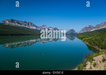 Mountain reflections in a calm Lake Sherburne in Glacier National Park, Montana, USA. Stock Photo