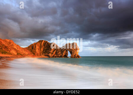 A stormy sunset at Durdle Door in Dorset. Stock Photo