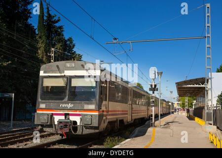 Renfe train at Salou Station platform with overhead power lines.