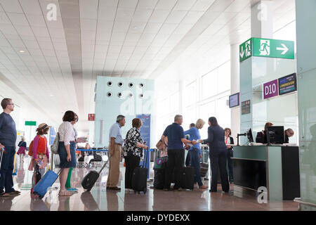 Passengers queuing to board at airport departure gate. Stock Photo