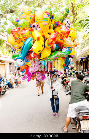 A balloon saleswoman at Hoi An market. Stock Photo