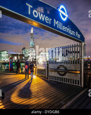 People looking up at The Shard at night from the Tower Millennium Pier. Stock Photo