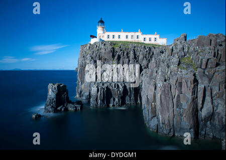 Neist Point Lighthouse perched on the edge of a cliff. Stock Photo