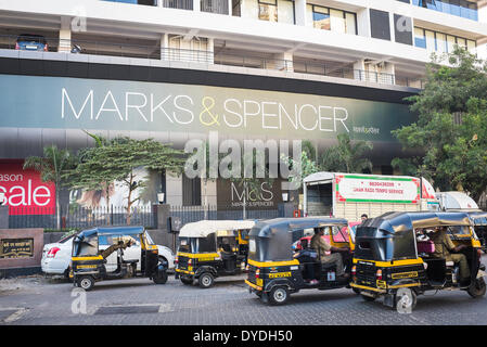 Auto rickshaws and a delivery van outside a Marks and Spencer department store in Mumbai. Stock Photo