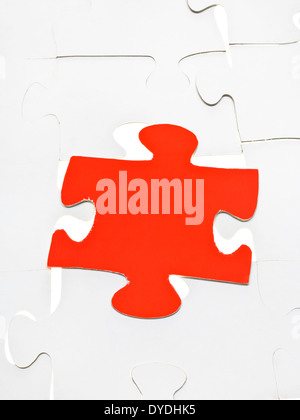 red puzzle piece on layer assembled puzzles Stock Photo