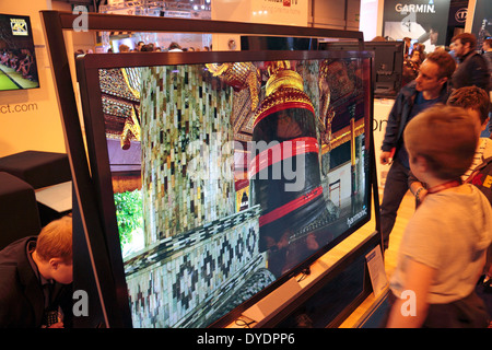 People looking closely at a Finlux UHD television at the Gadget Show Live 2014 show at the NEC, near Birmingham, UK. Stock Photo