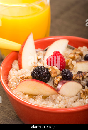 Bowl of steel cut oats served with fresh fruit and honey Stock Photo