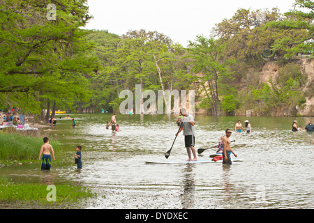 Crowd enjoying cool crystal clear waters of Frio River in Garner State Park Texas Stock Photo
