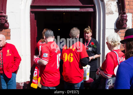 Anfield, Liverpool, UK. 15th April, 2014. On the 25th anniversary of the Hillsborough disaster over 20,000 fans visit Liverpool Football Club's grounds at Anfield to pay their respects to the 96 who died. Stock Photo