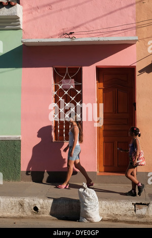 Schoolgirls walking along a residential street in Trinidad, Cuba. Stock Photo