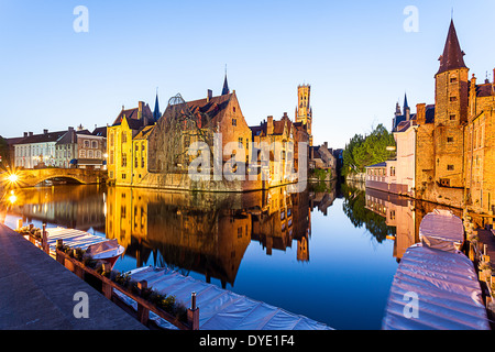 In Brugges at sunset during the blue hour, you see the refection of the building and the tower Stock Photo