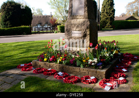 War memorial and thatched cottage, Old Bletchley, Buckinghamshire, England, UK Stock Photo