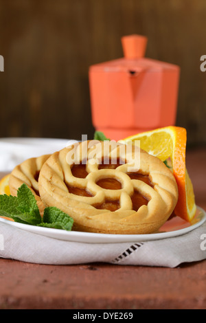 mini dessert tarts with orange on wooden table Stock Photo