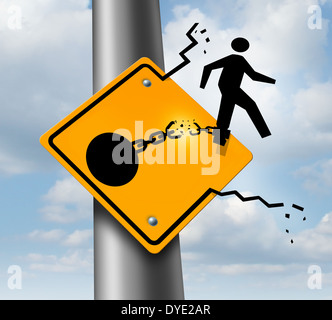 Escaping to freedom business concept as a businessman symbol on a traffic sign breaking free from the restrains of a ball and chain as a success metaphor of a new career or conquering adversity and emotional stress. Stock Photo