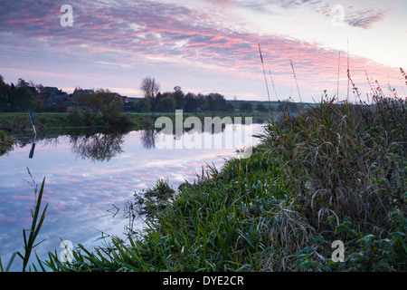 The River Nene at sunset beside the village of Denford near Thrapston in east Northamptonshire, England Stock Photo