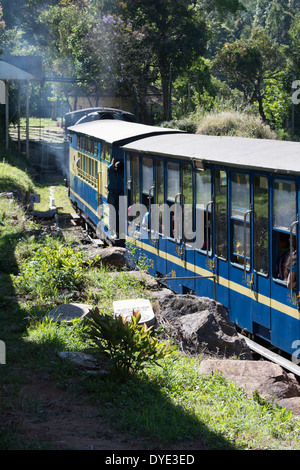 A Nilgiri Mountain Railway steam train makes progress through the Nilgiri Hills, Tamil Nadu, India Stock Photo