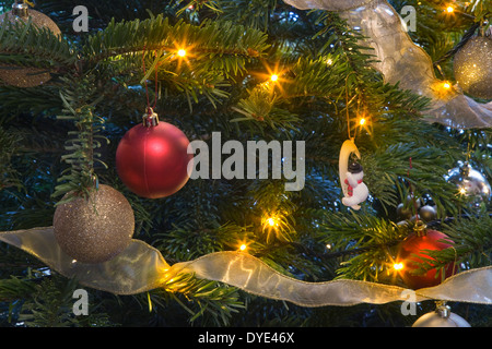 close up of Christmas Baubles on a illuminated Christmas tree Stock Photo