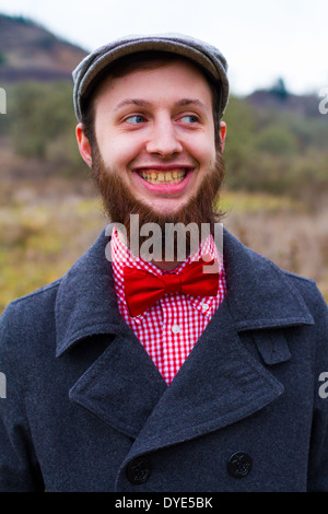 Trendy hipster guy outdoors in the winter in a fashion portrait of the handsome man. Stock Photo