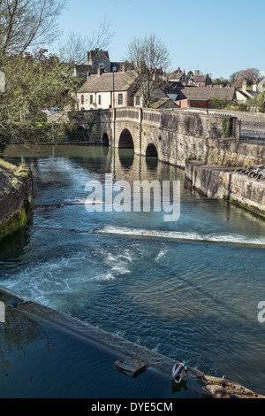 The flowing river Avon passing over the weir & under the bridge at the Southern entrance to Malmesbury, Wiltshire, UK Stock Photo