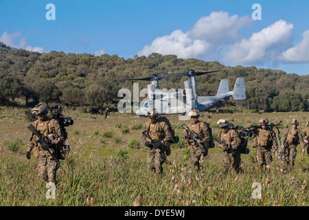 US Marines exit a MV-22 Osprey aircraft during an assault exercise February 24, 2014 in Sierra del Retín, Spain. Stock Photo