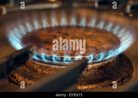 A close up of a blue gas flames burning on a kitchen cooker gas rig or burner Stock Photo