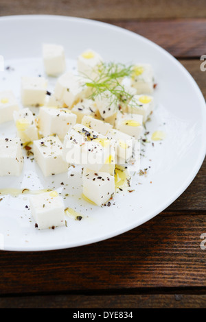 feta cubes with spices and oil, food closeup