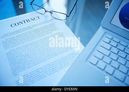 Image of document, eyeglasses and laptop on workplace Stock Photo