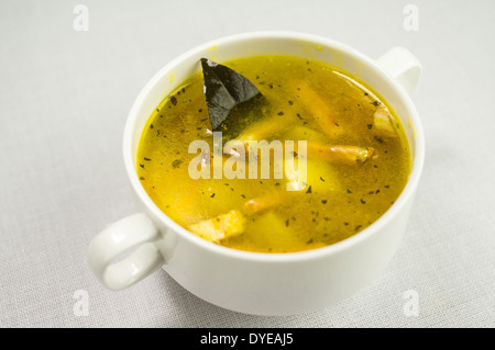 Soup with bacon, peas and vegetables and bay leaf Stock Photo