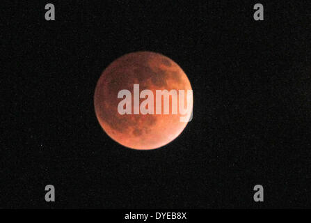 Anchorage, Alaska, USA. 14th Apr, 2014. The Earth's shadow cast a blood-red hue on the face of the moon, called the Blood Moon. The total lunar eclipse, which was visible from most of North and South America, Hawaii and Alaska. lasted about 3.5 hours between late Monday night and early Tuesday. The April 14th eclipse is the first of four consecutive total lunar eclipses that will occur between April 2014 and September 2015. The planet Mars also made its closest approach to Earth since 2008, during the same time as this lunar eclipse, making this a once in a lifetime event. (Credit Image: © Stock Photo
