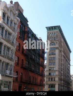 New York City tenement buildings in midtown New York. A mixture of housing and offices, this typical architecture dominated the city to the beginning of the 20th century, when elevators became widespread, enabling skyscapers. Stock Photo